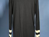 the back of a black dress with white stripes on a mannequin mannequin