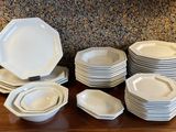 a lot of plates and bowls on the table