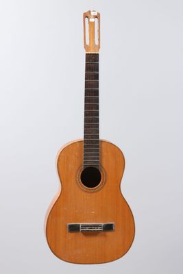 a close up of a wooden guitar on a white background