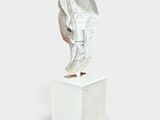 a sculpture of a hand holding a piece of paper