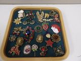 a tray that has a lot of brooches on it