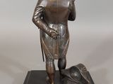 bronze statue of a man with a dog on a black base