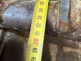 someone is measuring the height of a pipe with a measuring tape