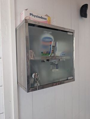 a metal box with toothbrushes and toothpaste on it