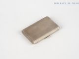 a small silver cigarette case sitting on a white surface