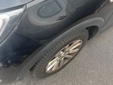 a picture of a black car parked in a parking lot
