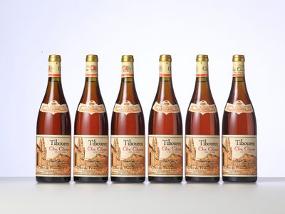 six bottles of wine are lined up on a table