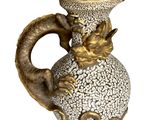 an image of a vase with a dragon head on it
