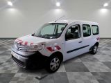 a small white van parked in a room with checkered flooring