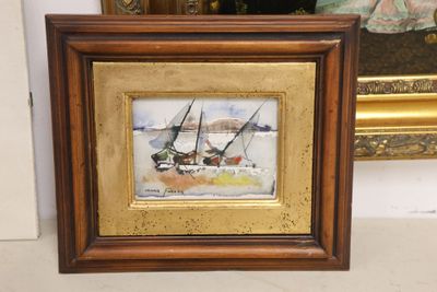 painting of a sailboat in a golden frame with a mirror in the background