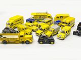 a lot of toy cars and trucks on a white surface