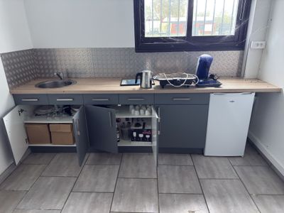 a small kitchen with a sink and a dishwasher in it