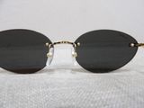 a close up of a pair of sunglasses on a white surface