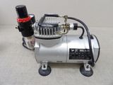 an image of a small air compressor on a table