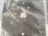 a black shirt in a clear plastic bag on a table