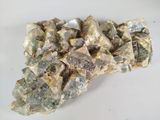 a large pile of rocks on a white surface