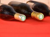 several bottles of wine are lined up on a red table