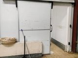a white door in a building with a broom in it