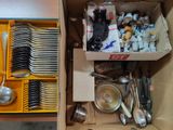 a box full of silverware and spoons in it