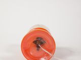 an orange plastic cup with a tiny insect inside of it
