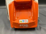 a close up of an orange and white box with a charger on it