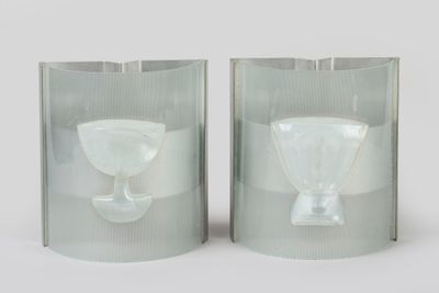 two glass vases that are sitting on a table
