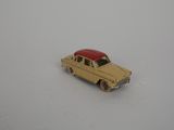 yellow toy car with a red roof on a white surface