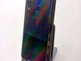 a close up of a cell phone on a stand on a table