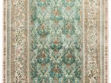 a blue and green rug with a medallion design on it