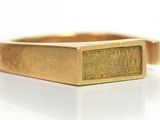 an image of a close up of a gold ring on a white surface