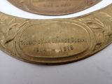 a gold plate with a plaque on it