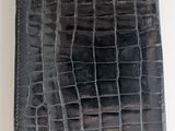 crocodile skin leather case for a tablet computer on a white surface