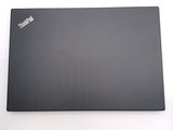 a black laptop sitting on a white surface