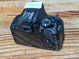 a black camera sitting on a wooden table