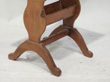 a small wooden table with a magazine rack on it