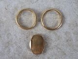 two gold rings and a gold ring with a gold ring on top