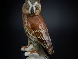 a figurine of an owl sitting on a branch