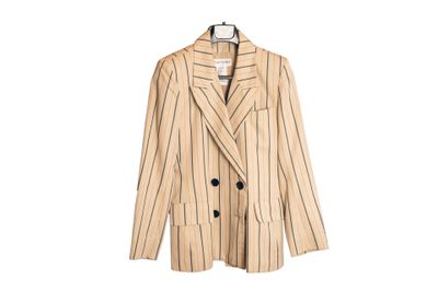 La veste est de couleur beige clair et noire, avec des rayures.