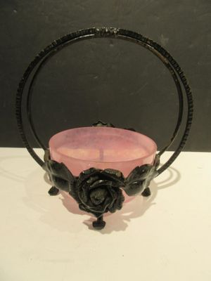a pink glass bowl with a rose decoration on it