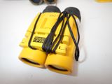 a pair of yellow binoculars on a white table
