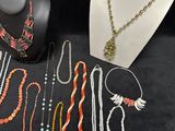 many necklaces and bracelets on display on a table