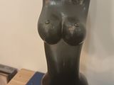 statue of a woman holding a baby in her arms on a blue table