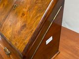 an old wooden desk with a drawer on top of it
