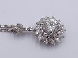 an image of a diamond necklace on a chain on a white surface
