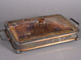 a silver plate with a lid that has food inside of it