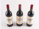 three bottles of wine sitting next to each other on a table
