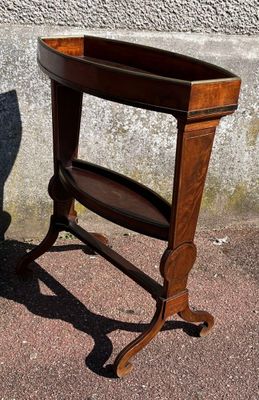 a small wooden table with a shelf on top of it