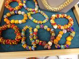many different colored beads and necklaces in a box