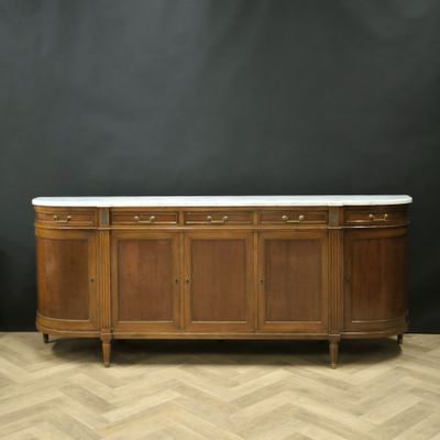 a very nice antique sideboard with marble top in the style of a buffet