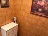 a small bathroom with a sink, toilet and a painting on the wall
